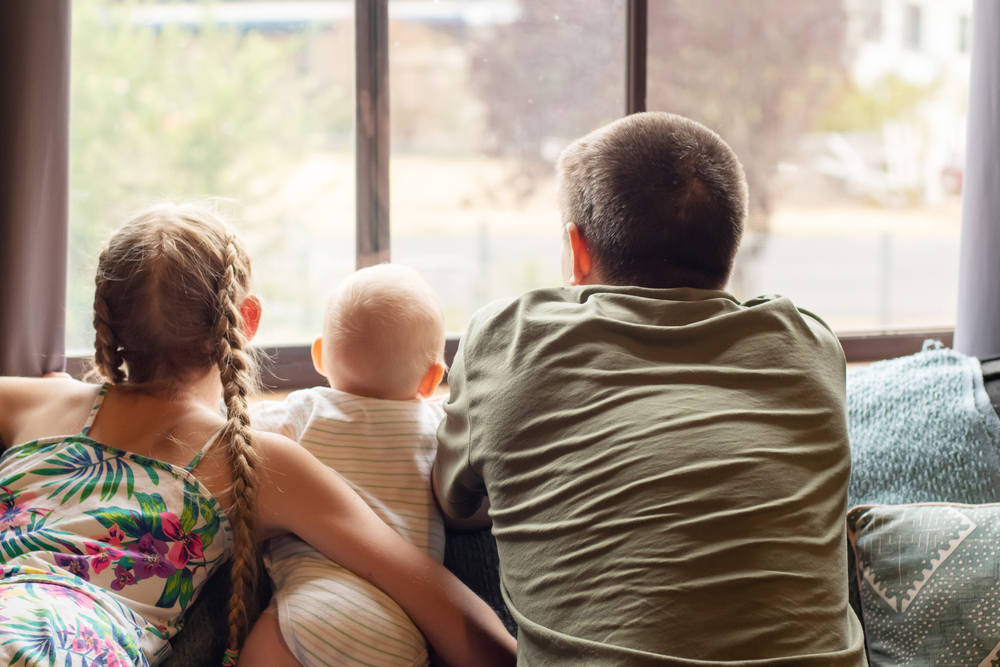 Family looking out window (4 Money-Saving Reasons to Switch to Energy Star Windows)